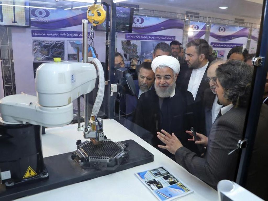 Der iranische Präsident Hassan Ruhani (M.) lässt sich neue Entwicklungen in der Atomenergie im Rahmen des «Nationalen Atomtags» erklären. Foto: Uncredited/Iranian Presidency Office/AP/dpa