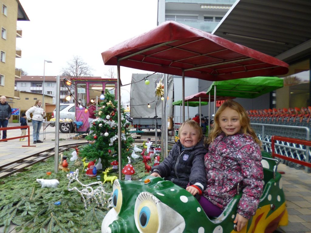 Der kleine Leon (4) und Jamilia (6) fahren mit der Eisenbahn. Derweil können die Erwachsenen auf dem Zollberger Weihnachtsmarkt Wurst und Glühwein genießen und festliche Deko für daheim einkaufen.